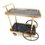 A mid 20th century brass drinks trolley, with inset hardstone gallery trays, raised on two pairs