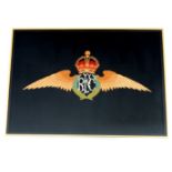 A framed embroidery of the Royal Flying Corps insignia, bearing label verso which reads 'Embroidered