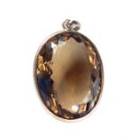 A large faceted, smokey topaz pendant set in a silver mount, Length (from top of pendant loop to