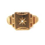 A 9 ct yellow gold signet ring centrally set with a diamond