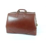 A large brown leather vintage Gladstone bag