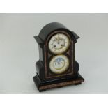 A late Victorian black slate and marble mantle clock