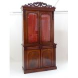 A Victorian mahogany bookcase, having an associated carved section