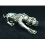 A white metal leopard sculpture