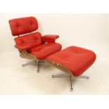 A contemporary red faux leather armchair with matching stool