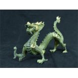 A Chinese bronzed dragon form pen rest; 26 cm long.