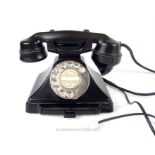 A GPO style converted black bakelite telephone with slide tray, stamped 'GPO No 164, TE 32/234' to