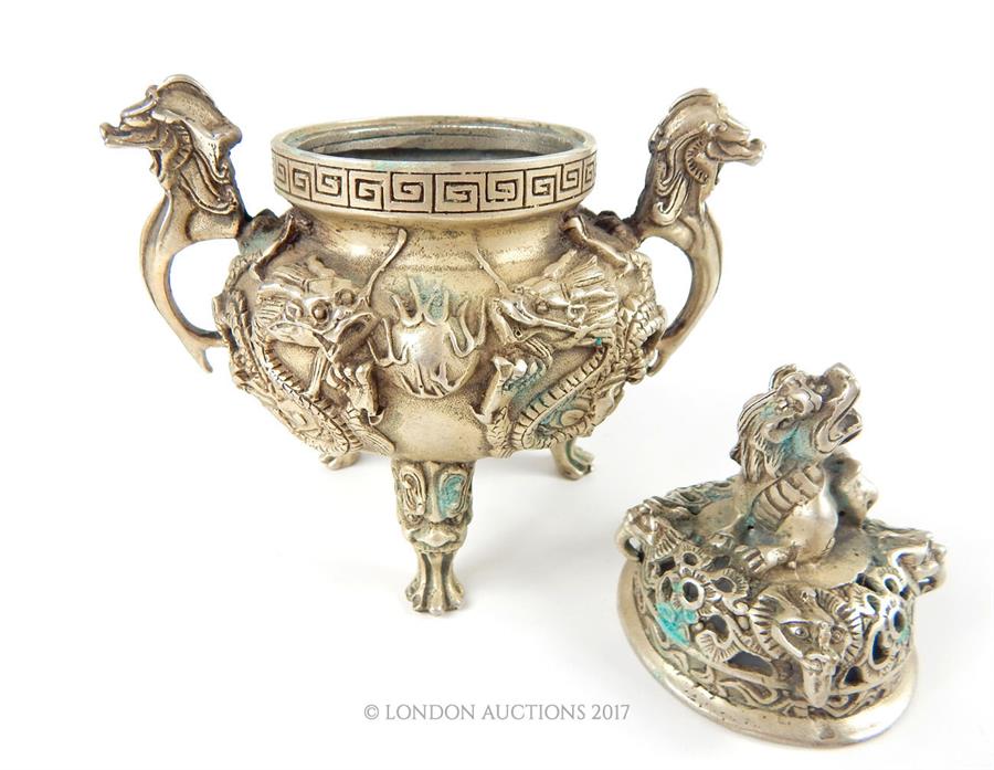 A Chinese white metal twin handled incense burner, the pierced lid cast with a model of a dragon and - Image 2 of 3