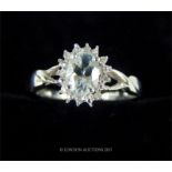 A 10 ct white gold aquamarine and diamond cluster ring