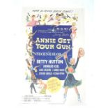 A vintage film poster of "Annie Get Your Gun"; folded and with some tears to middle sections; 104