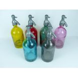 A set of six coloured glass soda siphons