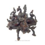 An Indian bronze sectional spice box, mounted with bird figures on five segmented compartments