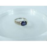 A 10 ct white gold and oval- shaped purple iolite solitaire ring