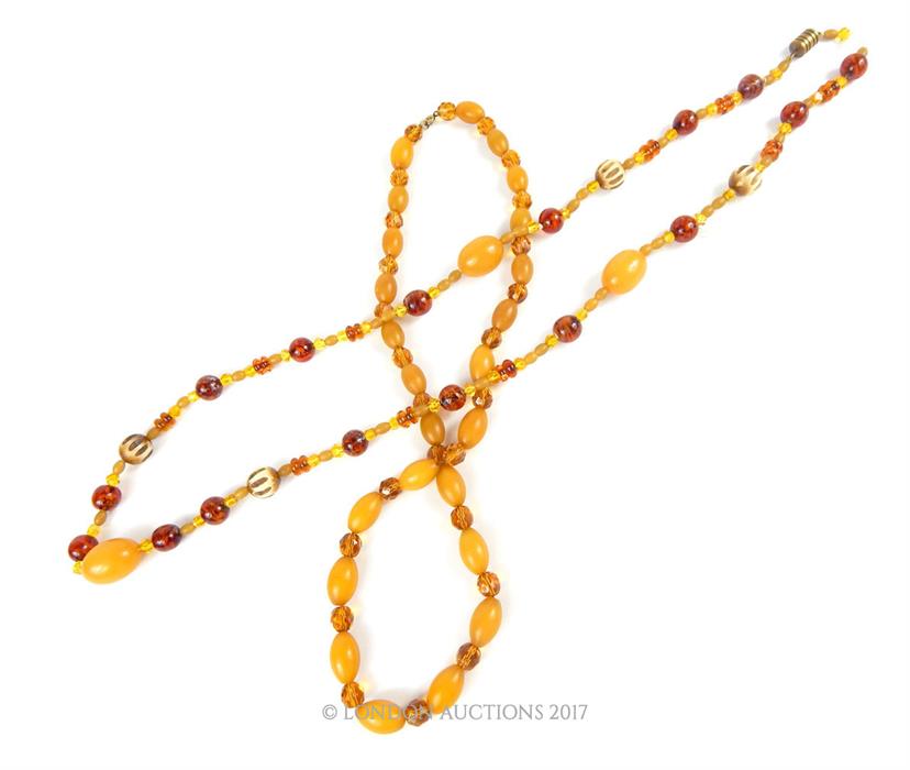 Two 1920s, possibly Baltic amber bead necklaces, each set with faceted glass spacers, one with