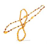 Two 1920s, possibly Baltic amber bead necklaces, each set with faceted glass spacers, one with