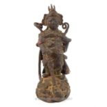 An antique Chinese cast iron figure of a warrior, having some evidence of the original paint, with