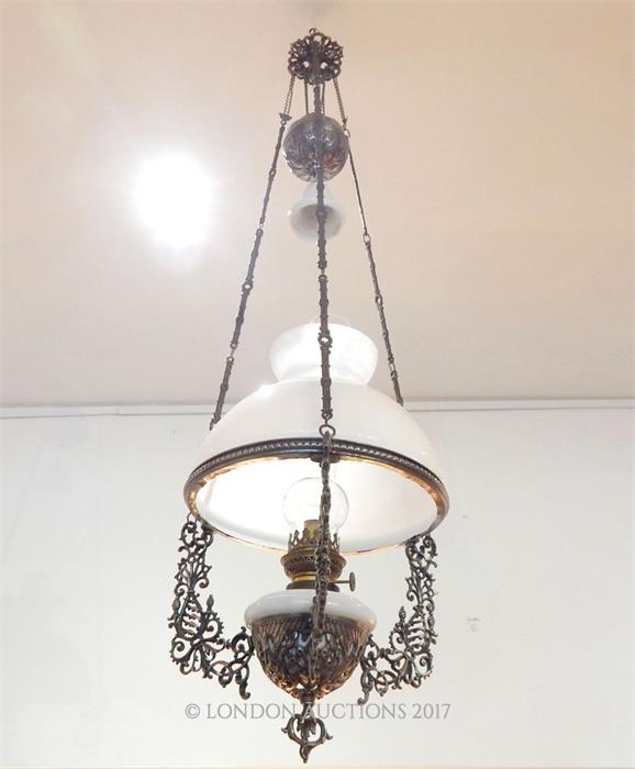 A mid / late Victorian painted spelter rise and fall ceiling oil lamp and shade.