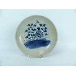 A Chinese crackle glazed porcelain dish, hand painted with under glaze cobalt blue flowers