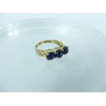A 9 carat gold cabouchon sapphire trilogy ring; weight 3.4 g; size N