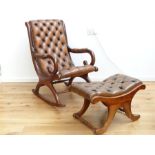 A brown buttoned leather and mahogany slipper rocking chair with stool