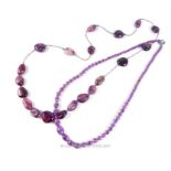 A graduated amethyst bead necklace with a white metal clasp, together with another amethyst bead