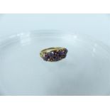 A 9ct yellow gold star amethyst and cabouchon amethyst ring