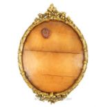 A turn of the last century oval gilt wood picture frame, with gesso vine detailing