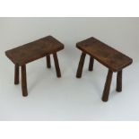 A pair of antique elm pig benches of rectangular form, raised on chamfered supports