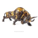 A 20th century large bronze bull sculpture decorated with gilded floral motifs.