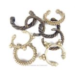 Four small Bedouin white metal bracelets together with four blackened metal bracelets with rope