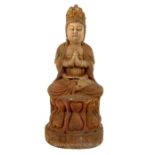 A late 19th / early 20th century Chinese carved wooden figure of the seated Guanyin, raised on