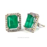 A pair of emerald and diamond cluster earrings