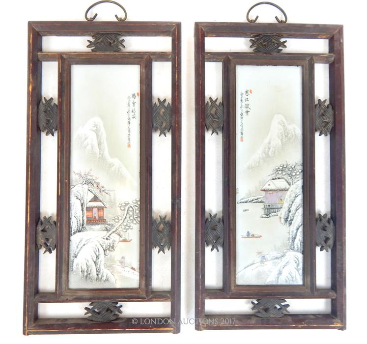 A pair of Chinese, Republic period enamelled porcelain plaques, within a pierced hanging hardwood