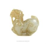 A Chinese carved jade figure in the form of a dragon