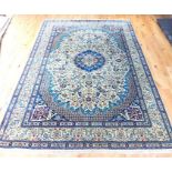 A fine part silk central Persian Nain carpet with a central blue medallion on a sage green field