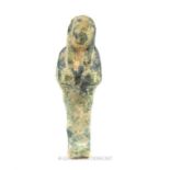 An Egyptian clay shabti with slight glaze; 11 cm long.