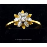 An 18 ct yellow and white gold diamond set flower head-shaped cluster ring