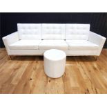 A contemporary cream leather button back and seated designer sofa, raised on four square chrome