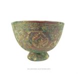 An Islamic bronze bowl with floral engraving amd also featuring a Persian signature to its base; 9.7