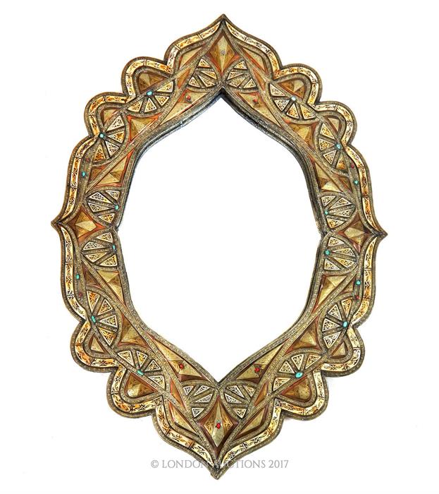 A North African mirror decorated with bone, copper, and embossed white metal