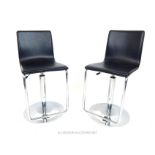 A pair of contemporary designer 'Z' framed chrome plated bar stools, with black leather seats,