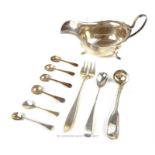A George V silver sauce boat and a selection of condiment utensils