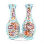 A pair of late 19th / early 20th century Chinese porcelain vases decorated in the famille rose palet