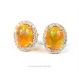 A pair of fire opal and diamond cluster earrings