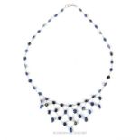 A fine,14 ct white gold and natural, faceted, sapphire 'floating' design necklace