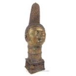 20th century bronze patinated Benin head of a queen with tall lattice headdress, pronounced marks to