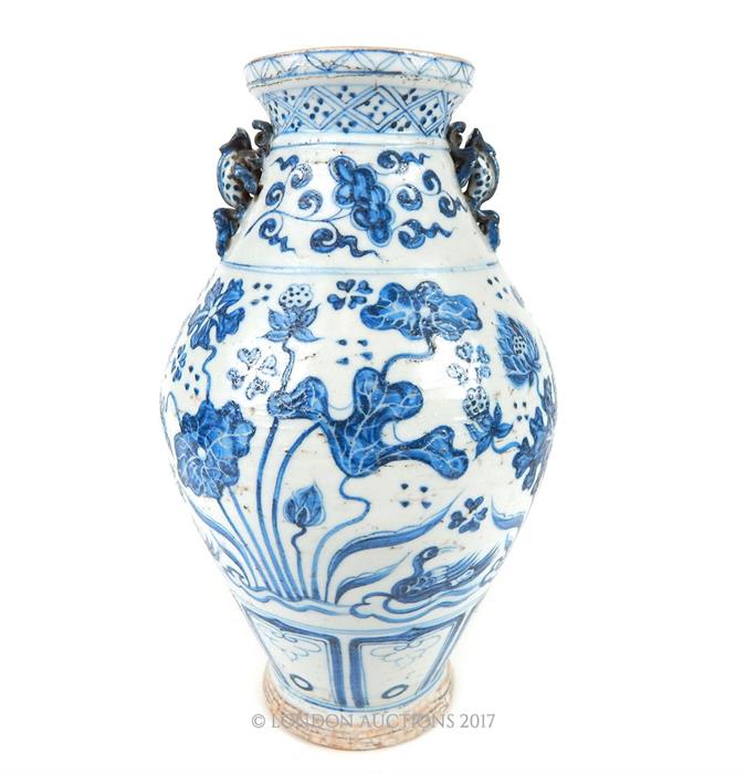 A Chinese Ming style blue and white pottery twin handled vase, with twin moulded handles in the form