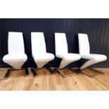 A set of four cream leather designer 'Z' framed dining chairs, each raised on chrome base.