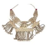 A large and ornate Bedouin white metal necklace with assorted a charms and naive designs.
