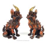 A pair of Chinese cast bronze Dogs of Fo, each seated in the crouch position, with gilt painted horn